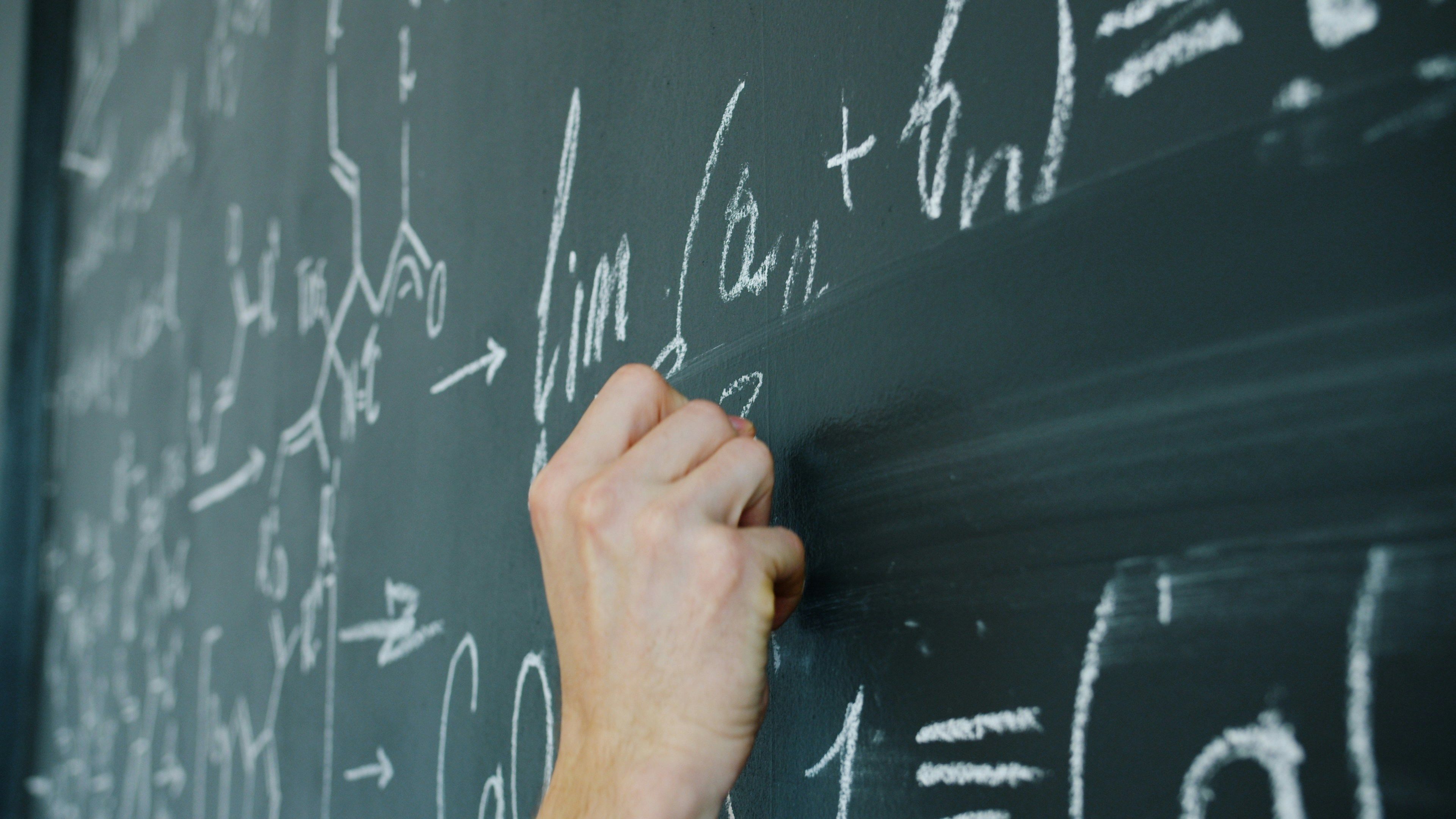 Mathematical equations on a chalkboard representing step-by-step reasoning